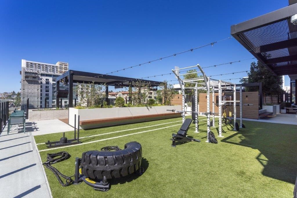A park with a black tire and a bench.