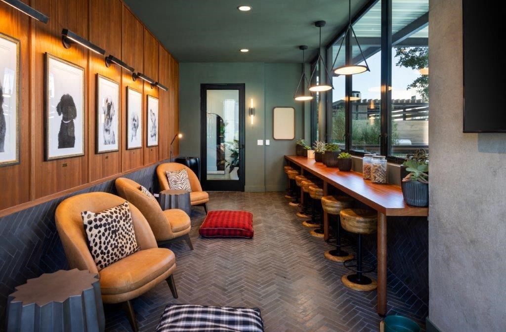 A long wooden table with a bench and a couch in front of it.