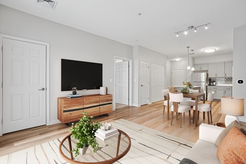 A modern living room with a white couch and a wooden coffee table.