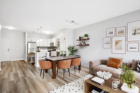 a living room and dining room with a table and chairs