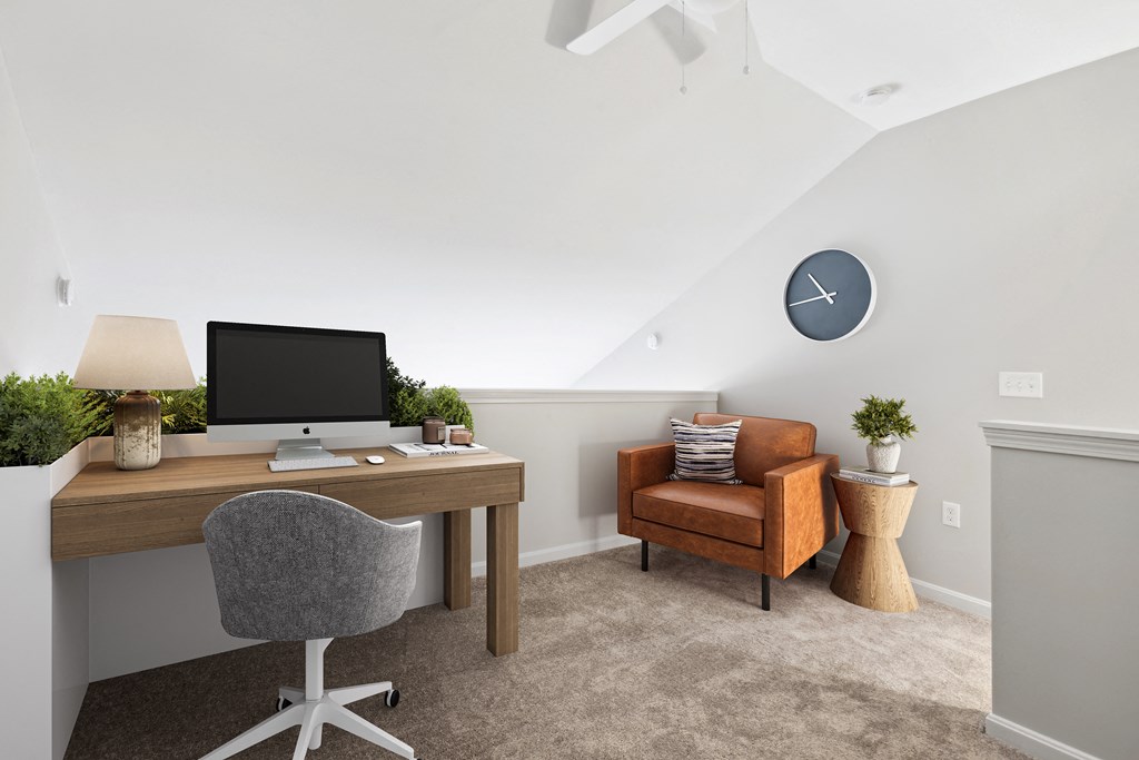 a bedroom with a desk and a chair and a clock on the wall