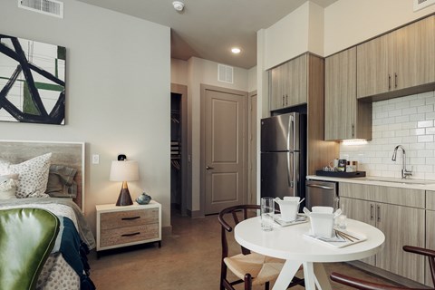 A modern kitchen with a dining table set for two.