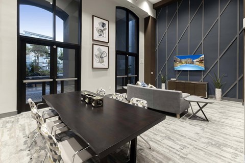 A modern dining room with a large table and chairs.