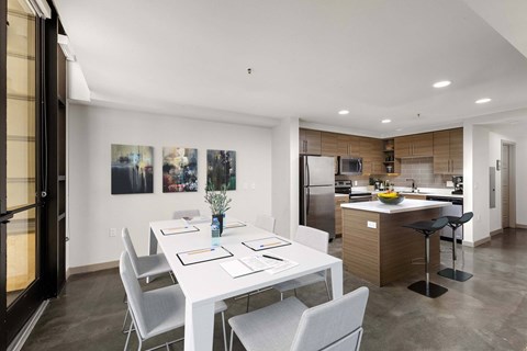 A modern kitchen with a dining table and chairs.