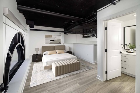 A modern bedroom with a large bed and a futuristic design on the wall.