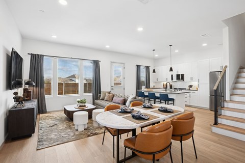 A modern dining room with a large table and chairs.