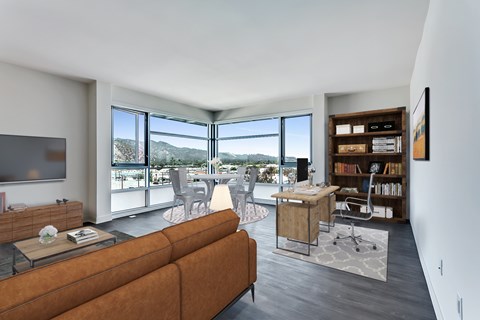 A living room with a brown couch and a television.