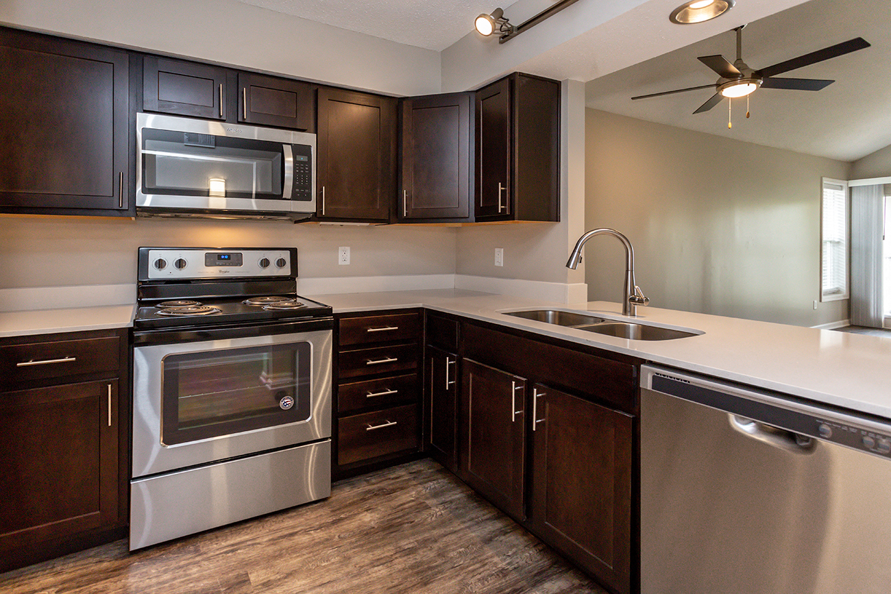 diamond kitchen with dark wood cabinets and modern appliances