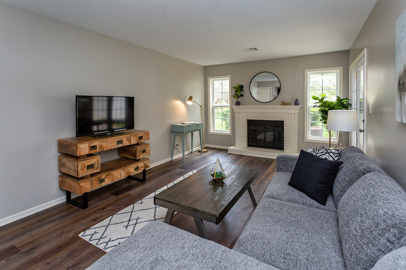 living room with fireplace, paneled windows, and comfortable furniture