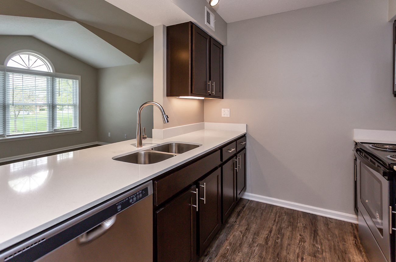 kitchen with modern appliances and cut-out to living room