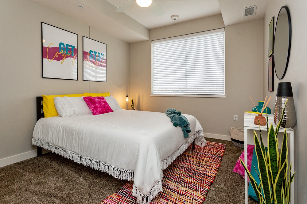 a guest bedroom with a large window