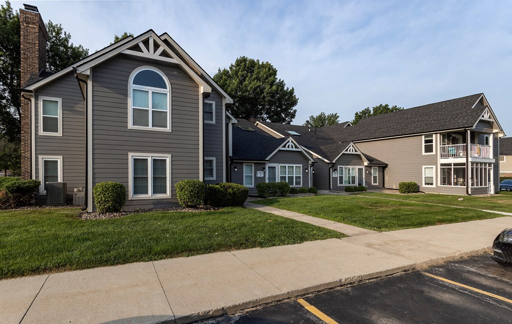 winwood apartment exterior with gray siding and arched windows