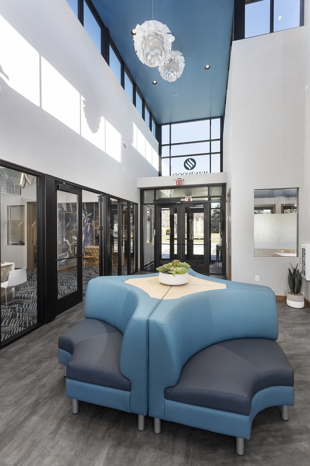 atrium with small couches near Marketing office