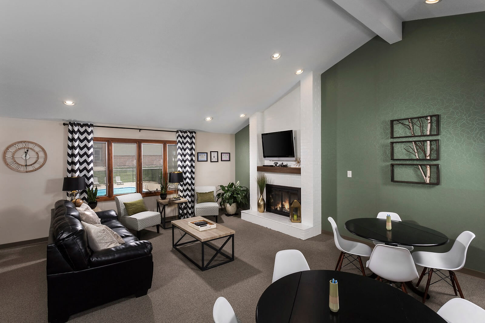 a living room with a fireplace and a table and chairs