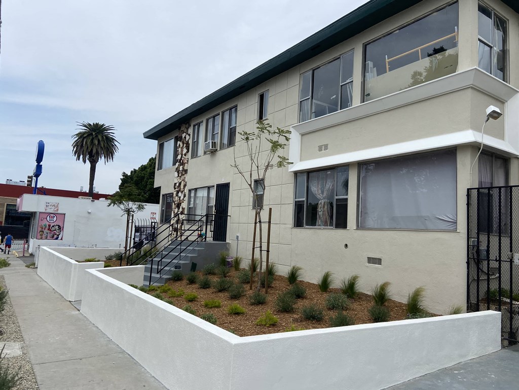 the exterior of a building with a sidewalk in front of it