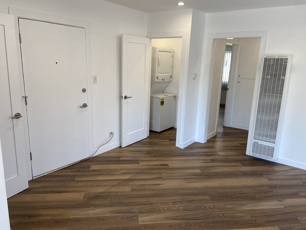 a renovated living room with wood floors and white closets