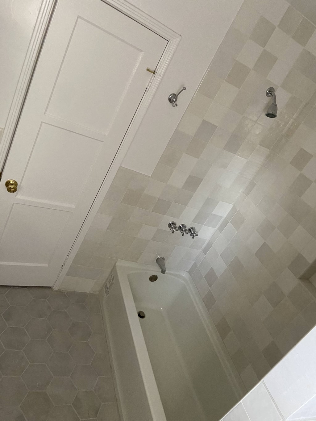 a small bathroom with a shower and a bath tub