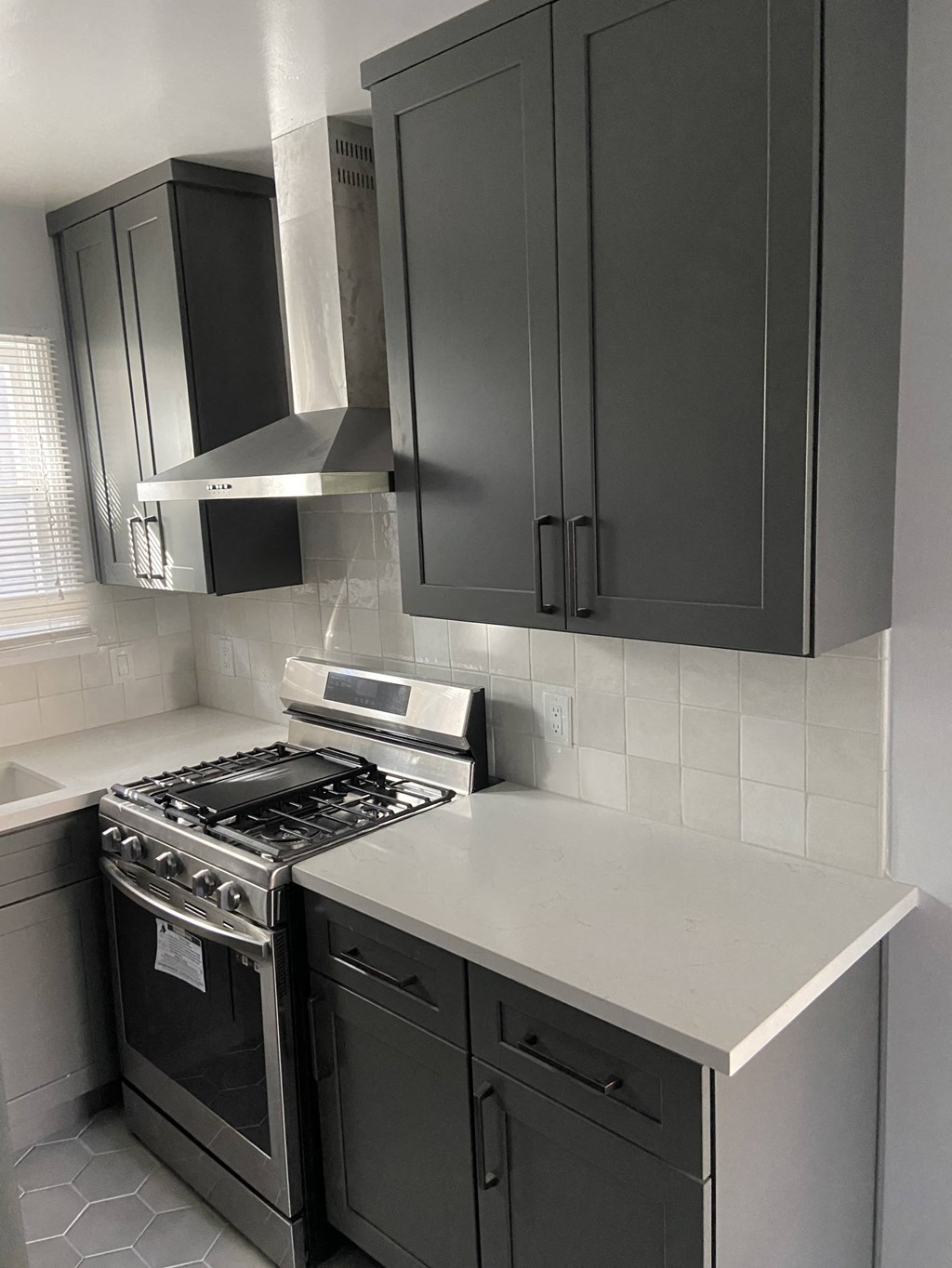 a black and white kitchen with a stove and cabinets