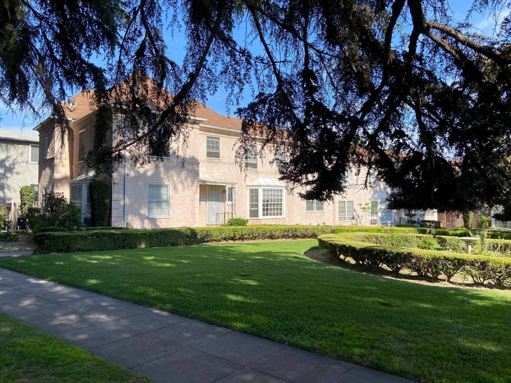 a large building with a lawn in front of it