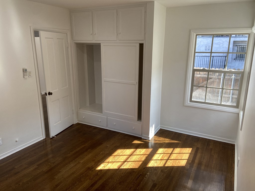 an empty room with a door and a closet