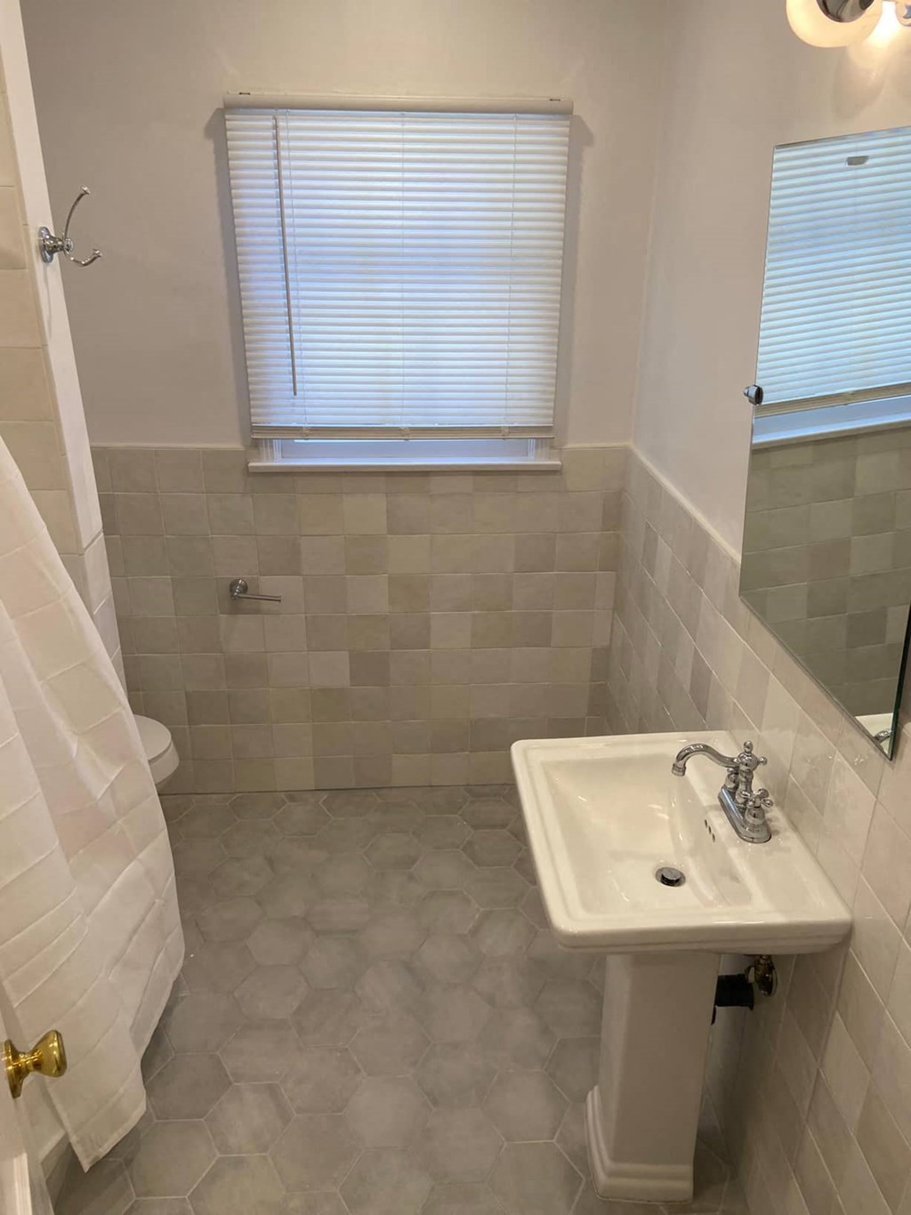 a small bathroom with a sink and a window