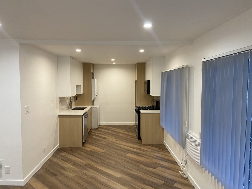 a kitchen and living room in an empty apartment