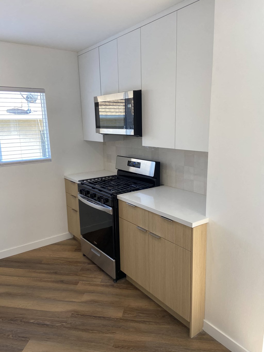 a small kitchen with a stove and a microwave