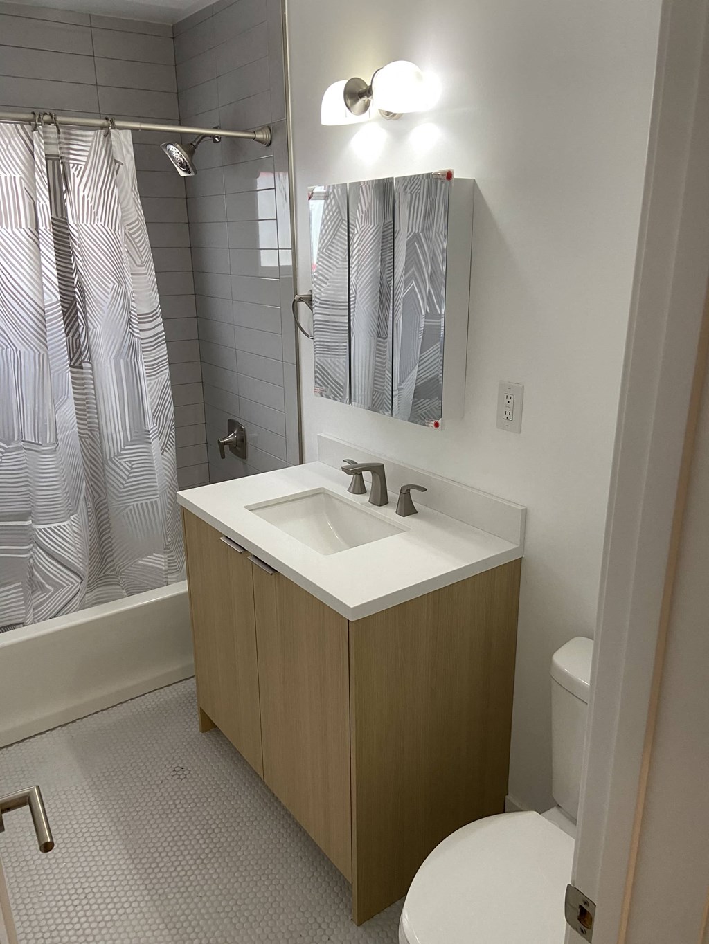 a bathroom with a sink and a shower and a toilet