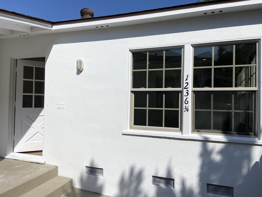the outside of a white house with windows