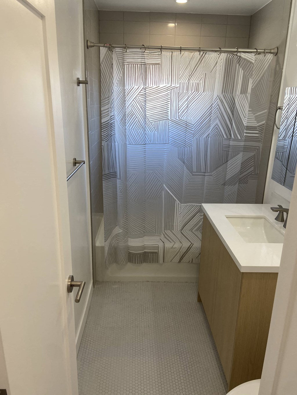 a small bathroom with a shower and a sink