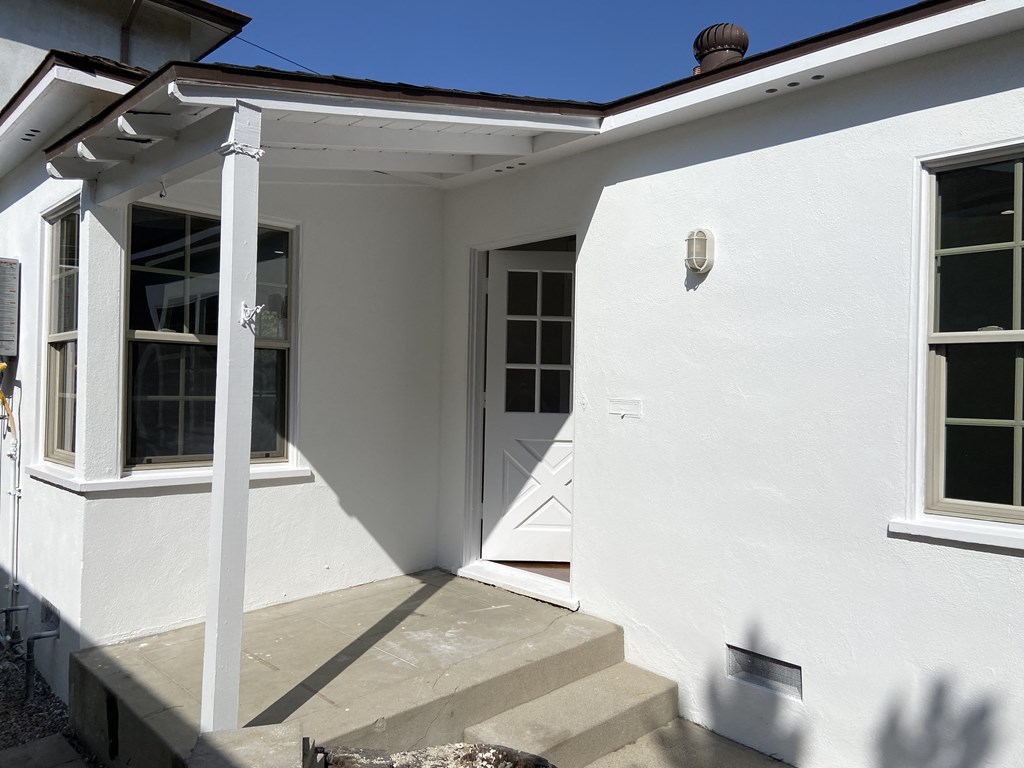 a view of the front entrance of a house with a porch