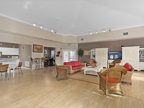 A living room with a red couch and a white table.