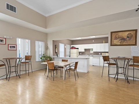 A kitchen with a table and chairs in the foreground.
