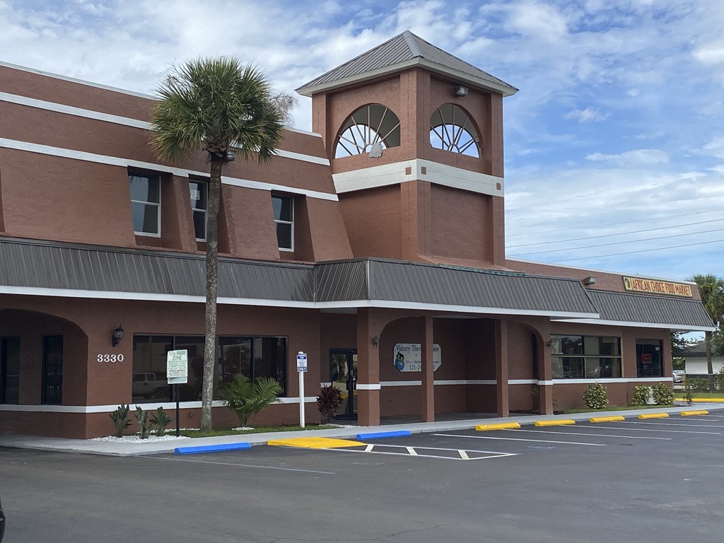 a building with a clock tower on top of it at Colonial Drive Apartments, Orlando, 32808