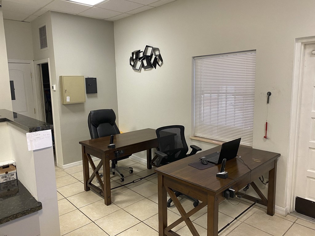 an office with two desks and two chairs at Colonial Drive Apartments, Orlando