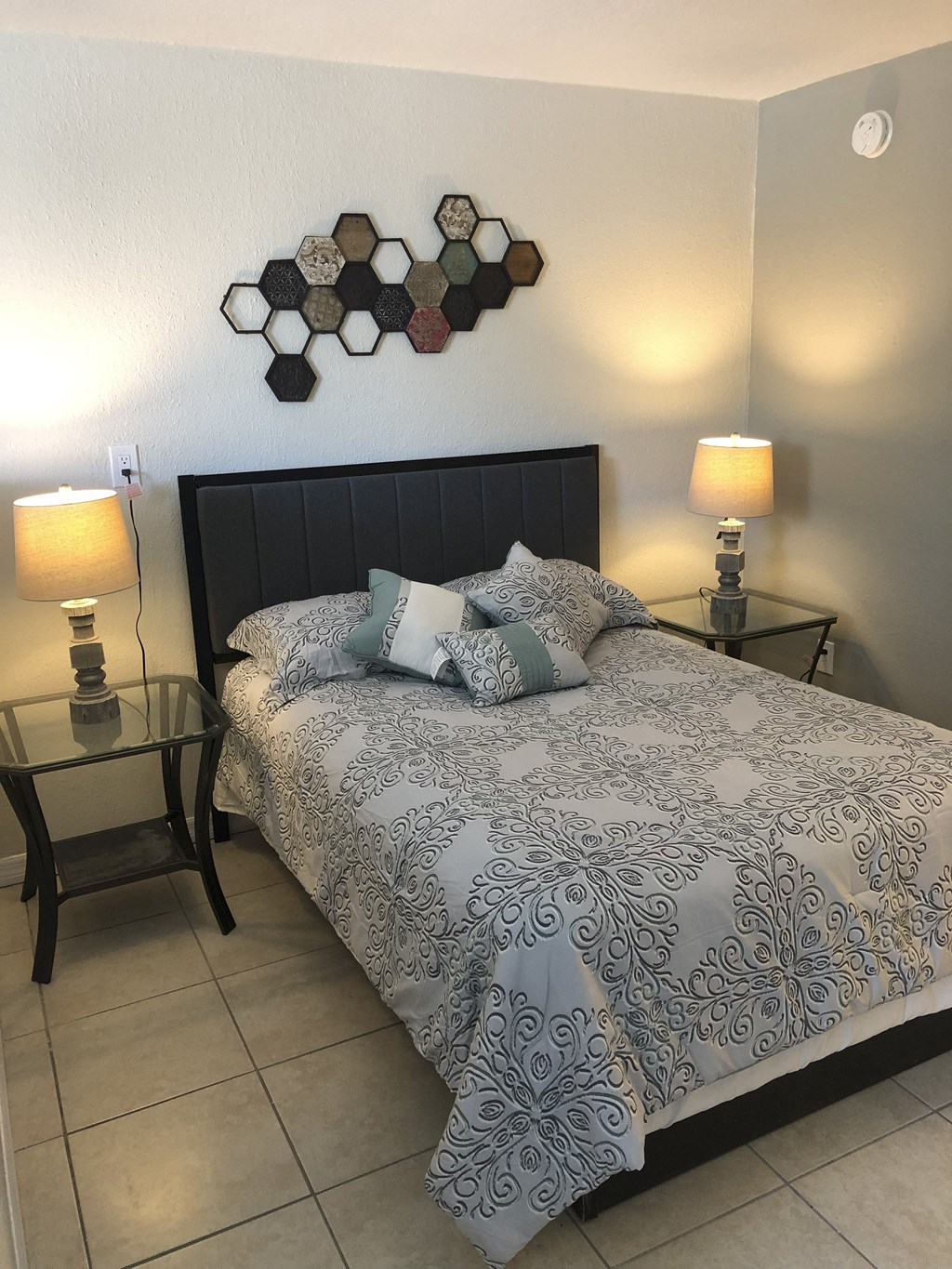 a bedroom with a bed and two night stands at Colonial Drive Apartments, Orlando Florida