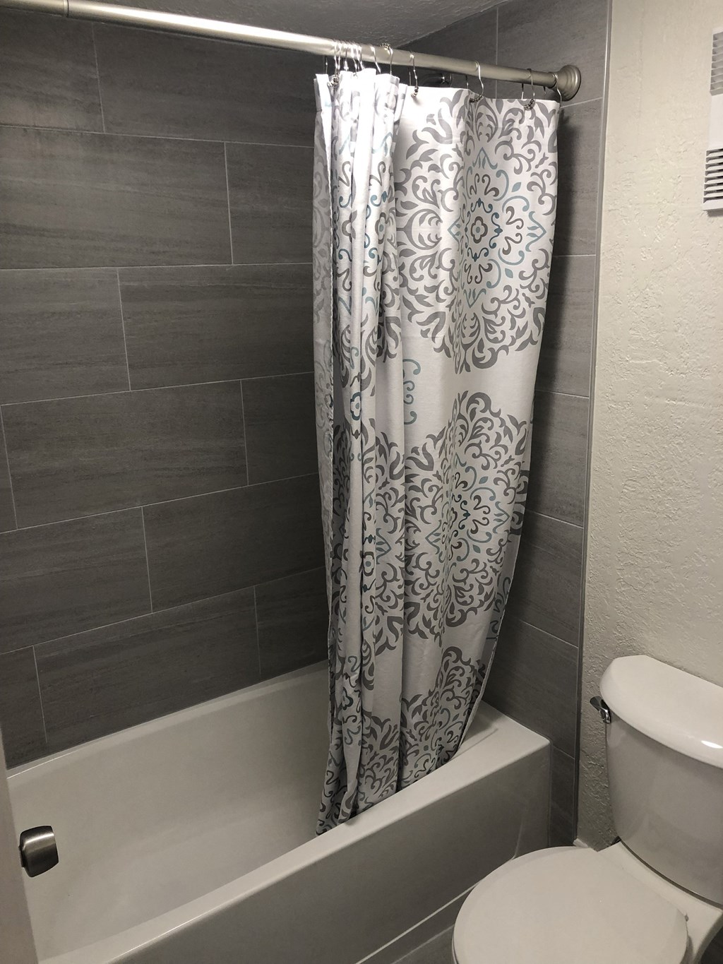 a bathroom with a toilet and a bathtub at Colonial Drive Apartments, Orlando, 32808