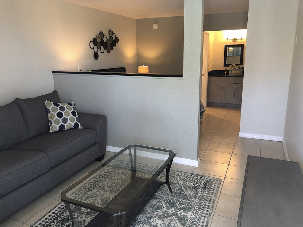 a living room with a couch and a coffee table at Colonial Apartments, Florida, 32808