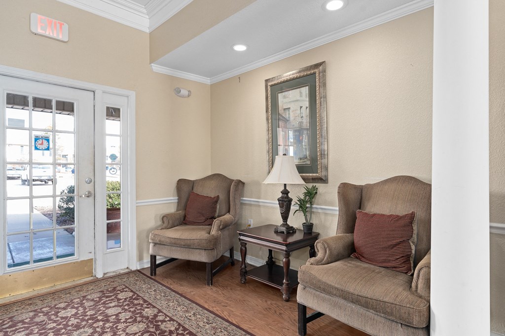 a living room with two chairs and a door to a patio