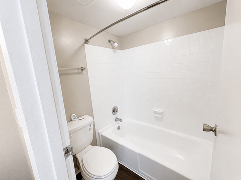 A white toilet is next to a white bathtub in a bathroom.