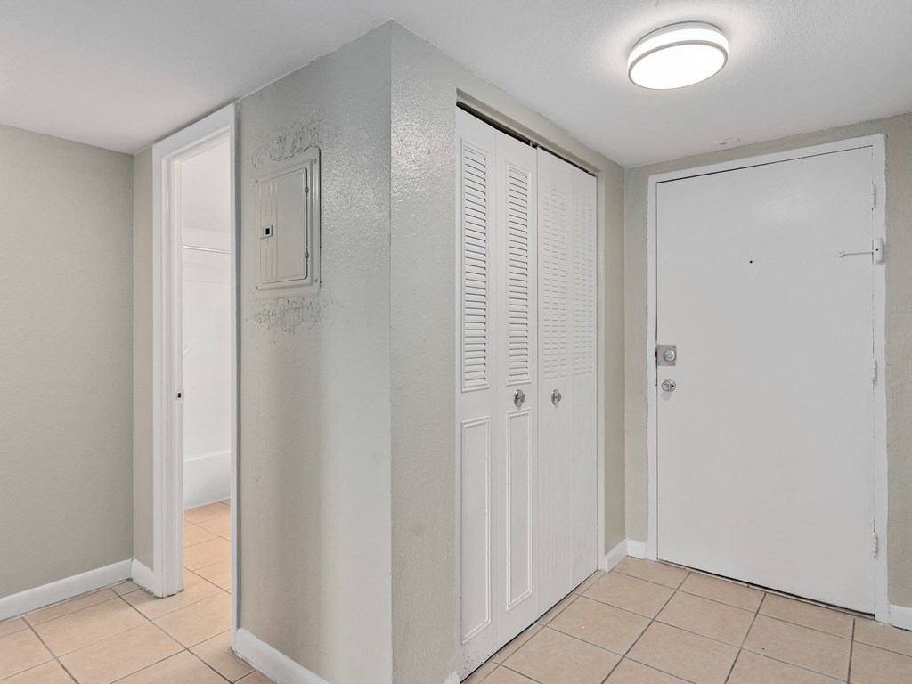 an empty room with two closets and a tiled floor