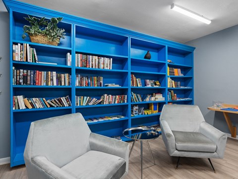 two chairs in front of a blue bookshelf at Cypress Grove, Lauderhill, 33313