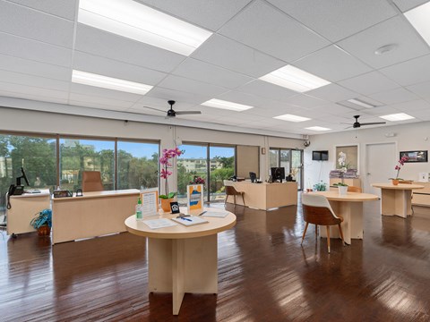 an office space with desks and chairs and a large window at Cypress Grove, Florida