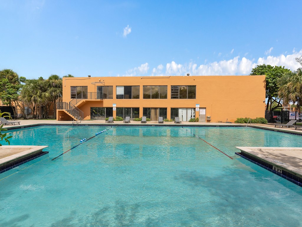a swimming pool with a building in the background