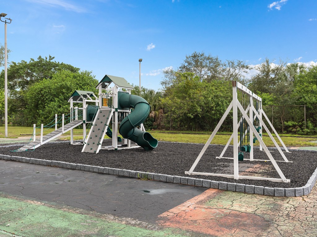 a playground with a swing set and a slide