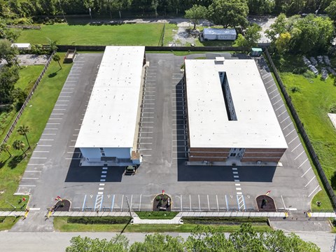 Aerial view of parking lot and commercial buildings at Southside Apartments, Florida