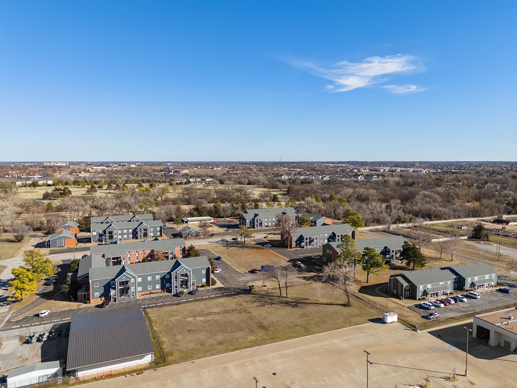 a aerial view of a neighborhood with houses and a city in the background