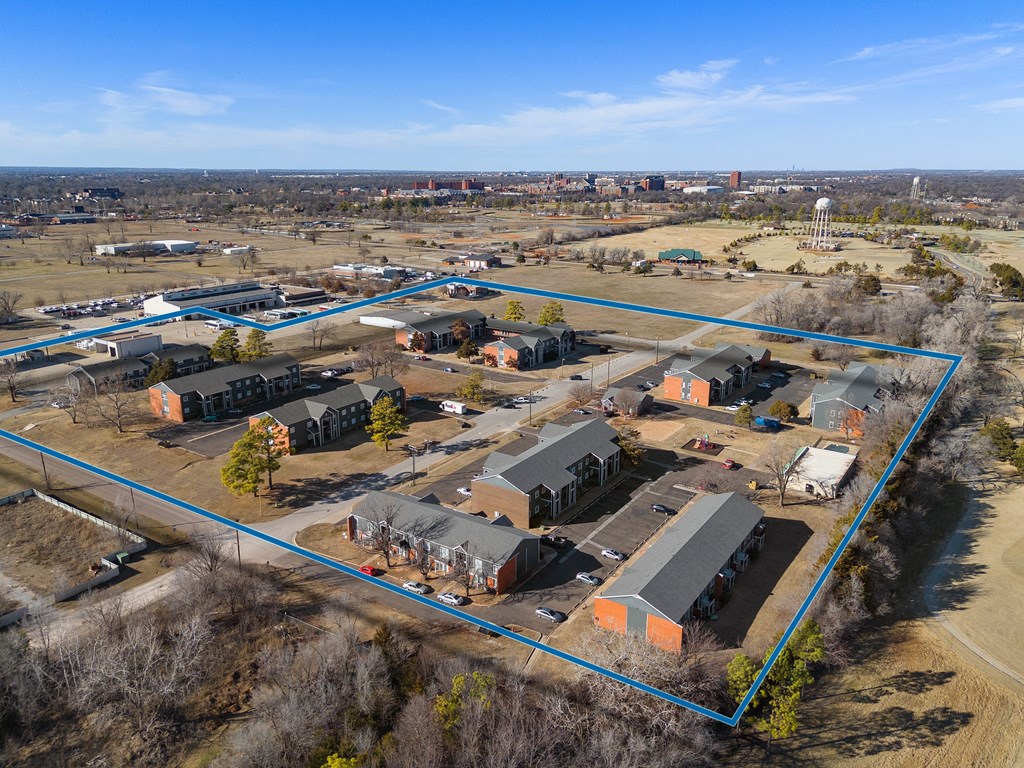 a birdseye view of a neighborhood of houses and a city in the background