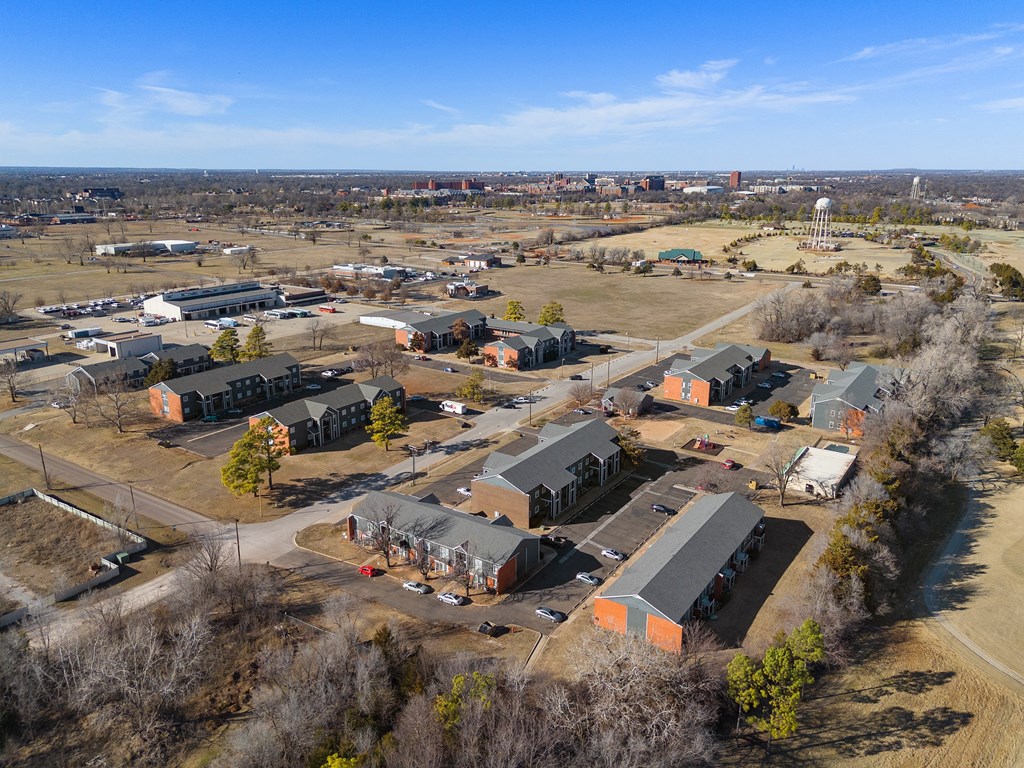 an aerial view of a neighborhood with houses and a city in the background