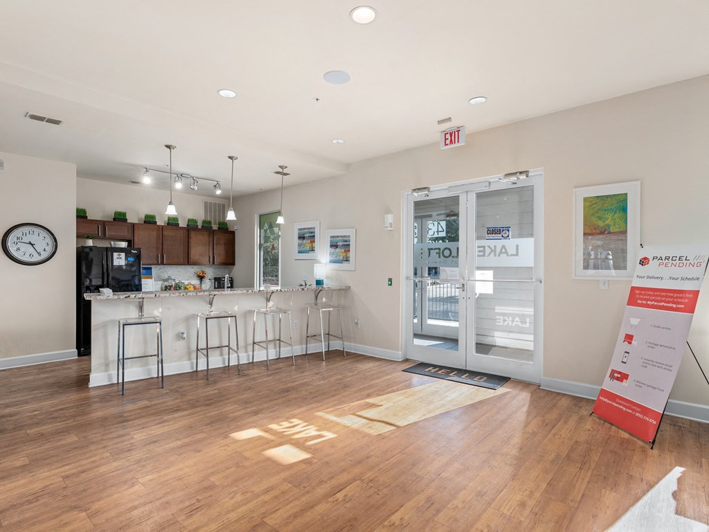 a common room with a kitchen and a door to the lobby of a building at Lake Lofts at Deerwood, Jacksonville, Florida
